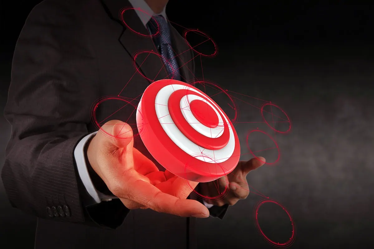 These 8 Vanguard Funds Can Take Your 401(k) to the Next Level 5 Concept art of a businessman holding up a digital bullseye.