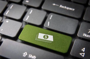 a key on a keyboard shows a symbol of a stack of cash.