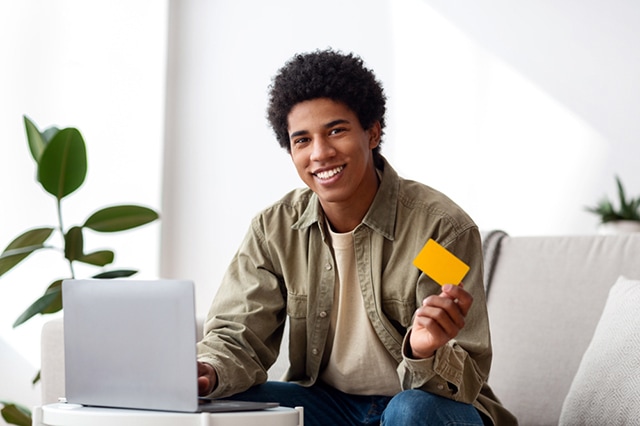 teen with debit credit card laptop