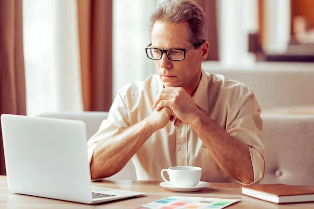 thinking retirement over laptop coffee 640