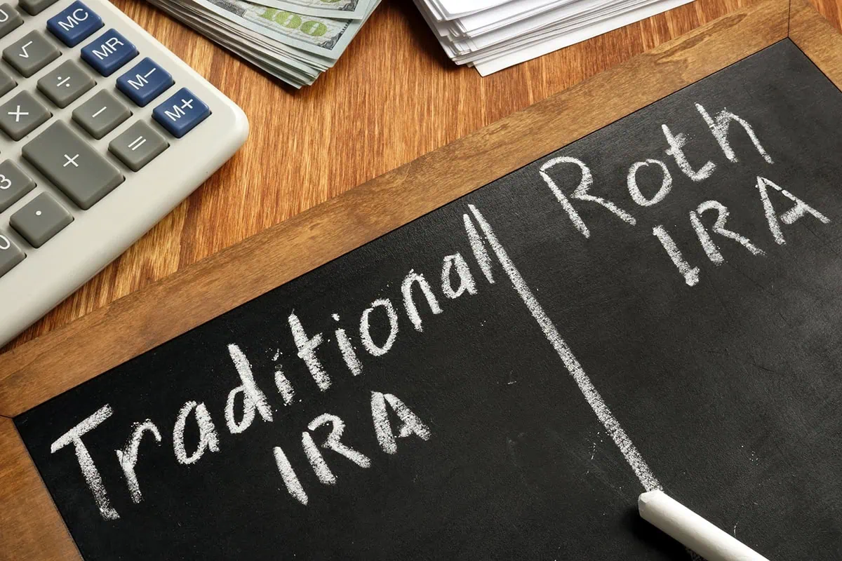 10 Common IRA Money Mistakes to Avoid 3 A chalkboard with traditional IRA on one side and Roth IRA on the other.