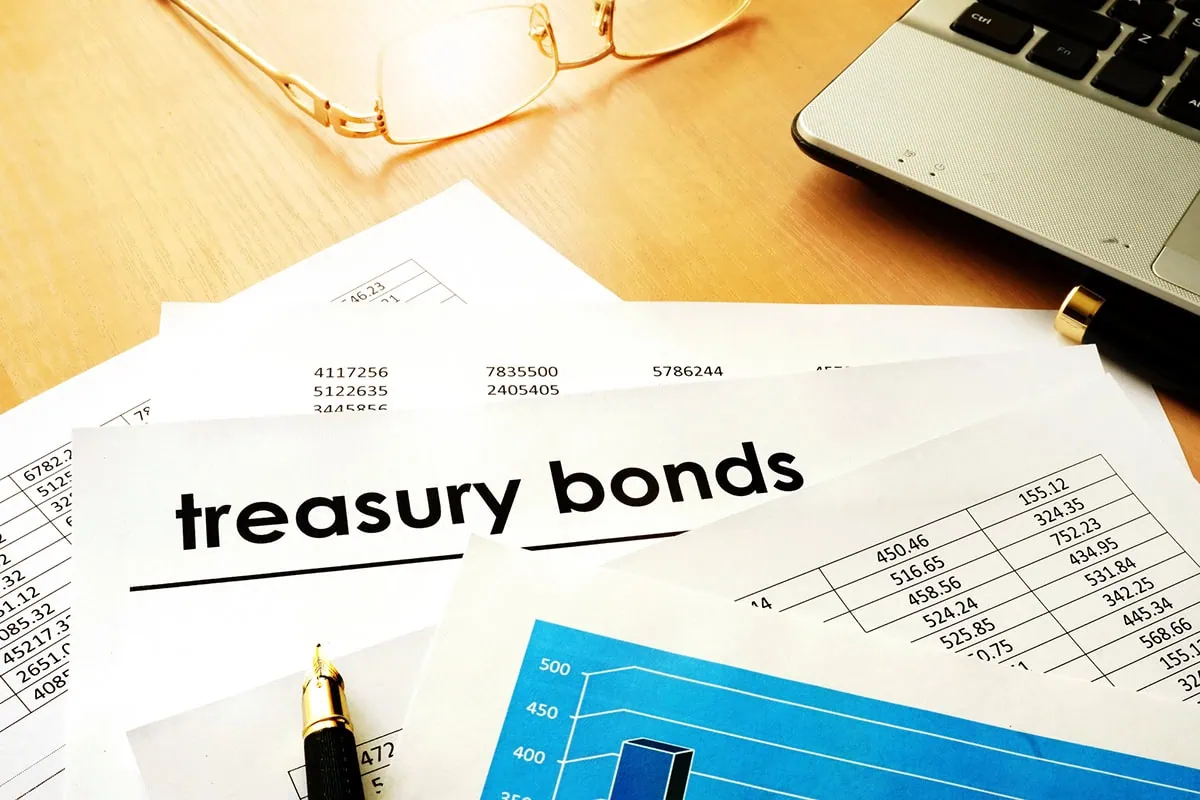 a stack of papers and one of them says treasury bonds.