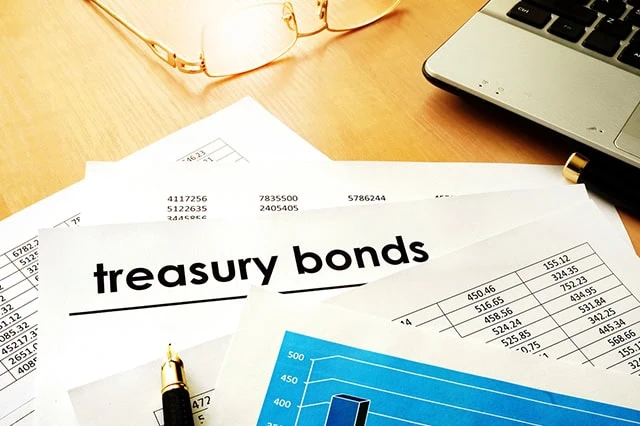 a stack of papers and one of them says treasury bonds.
