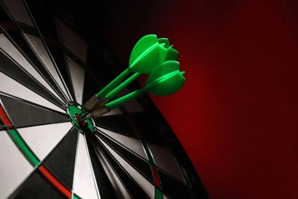 green darts in the bull's-eye of a dartboard.