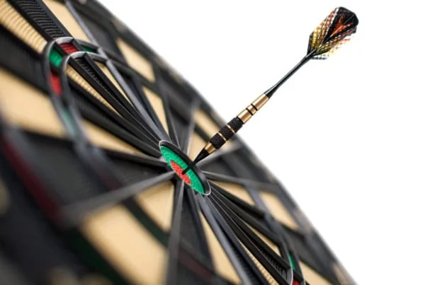 a multicolored dart hits a bullseye against a white background.