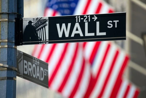 a sign saying wall street in new york city.