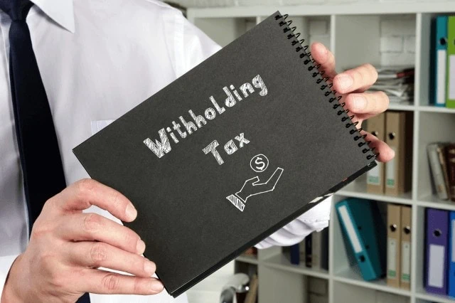 withholding tax written in notebook