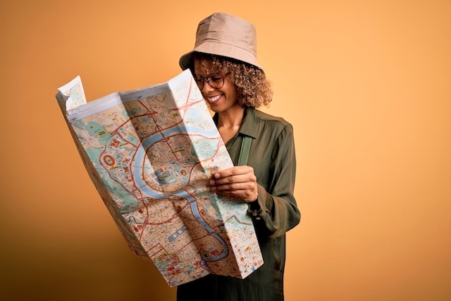 woman plotting a course on a map