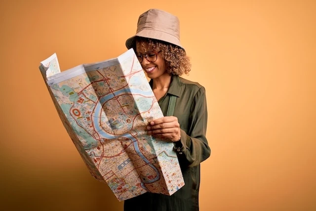 woman plotting a course on a map