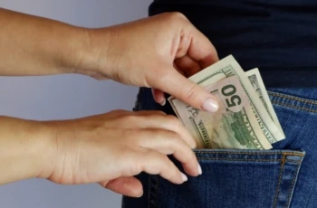 woman pulls money out of man's back pocket