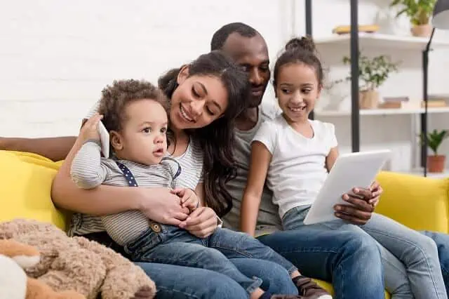 young family on coach tablet medium