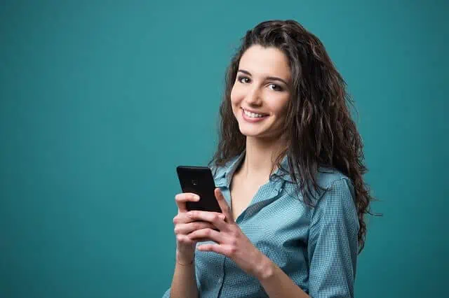 young woman on smartphone smiling