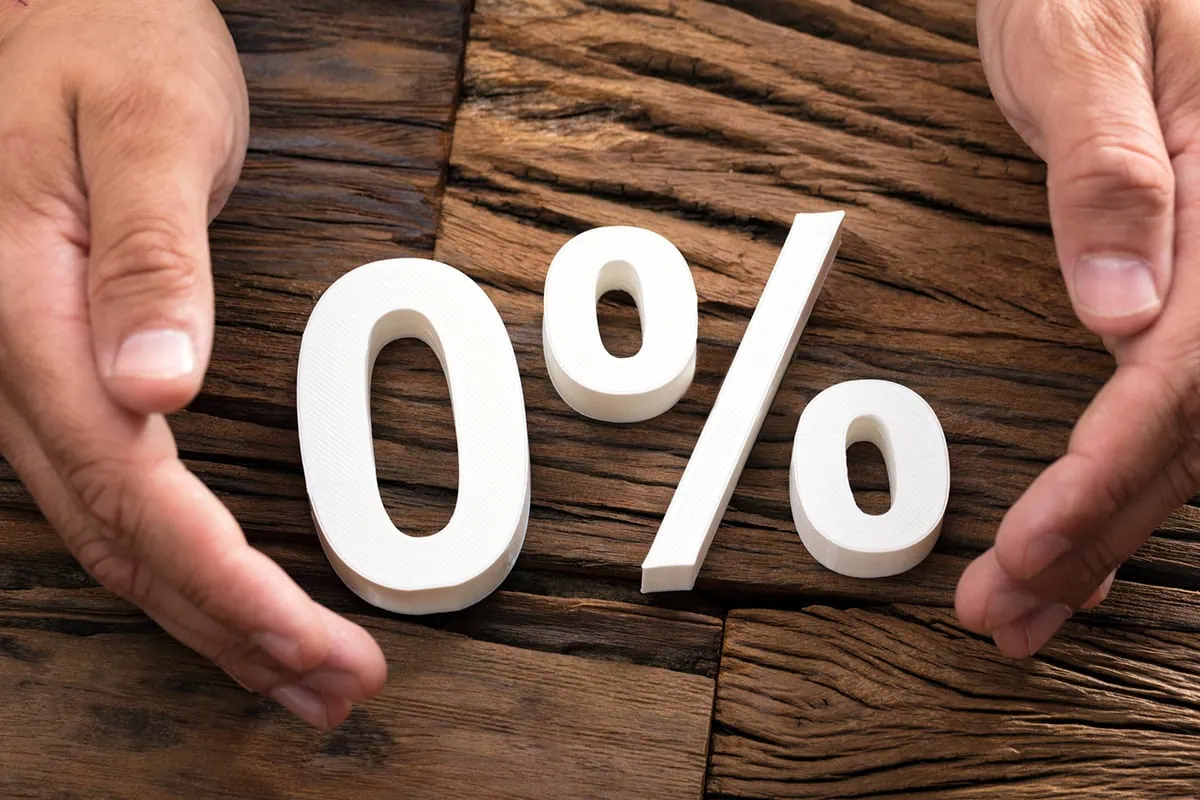 a person presents a zero percent sign between their hands.